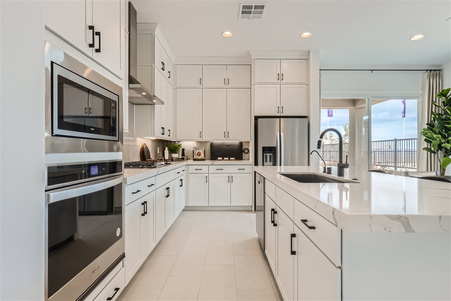 A kitchen with white cabinets.