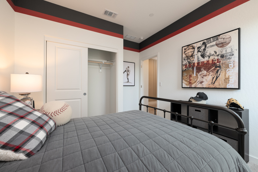 A bedroom with a bed and a poster on the wall.