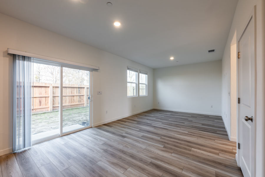 A room with a wood floor and windows.