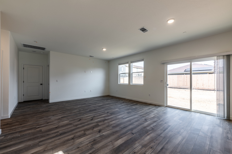 A room with a wood floor and windows.