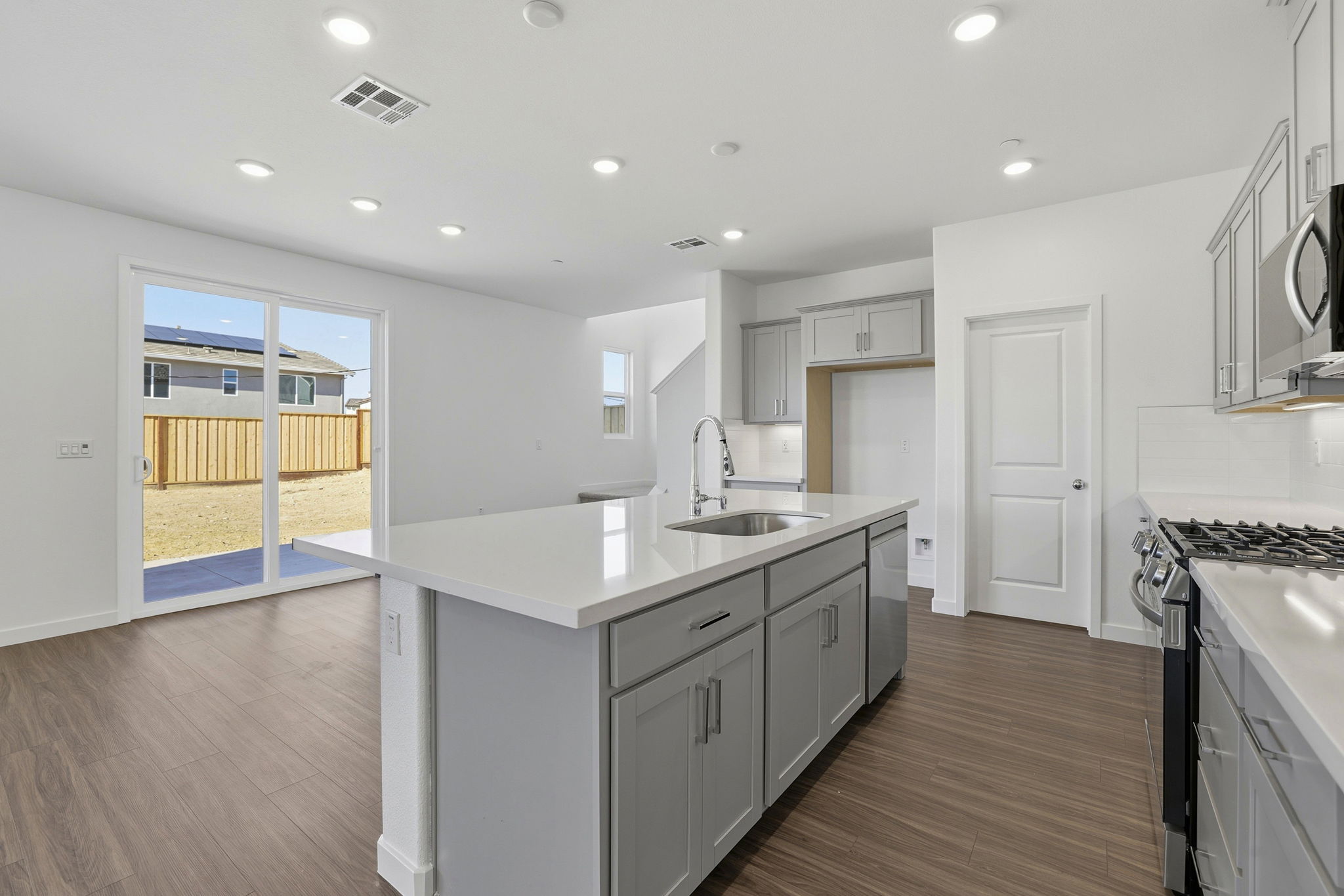 A kitchen with white cabinets.