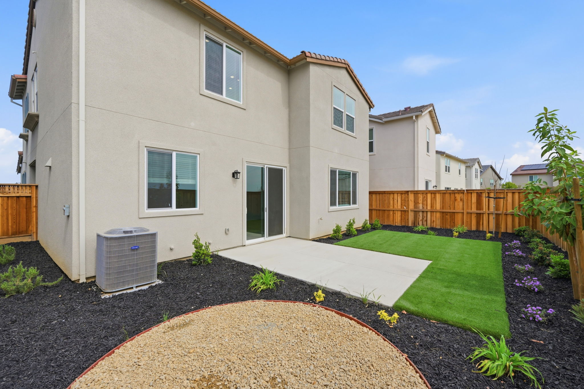 A house with a fence and yard.