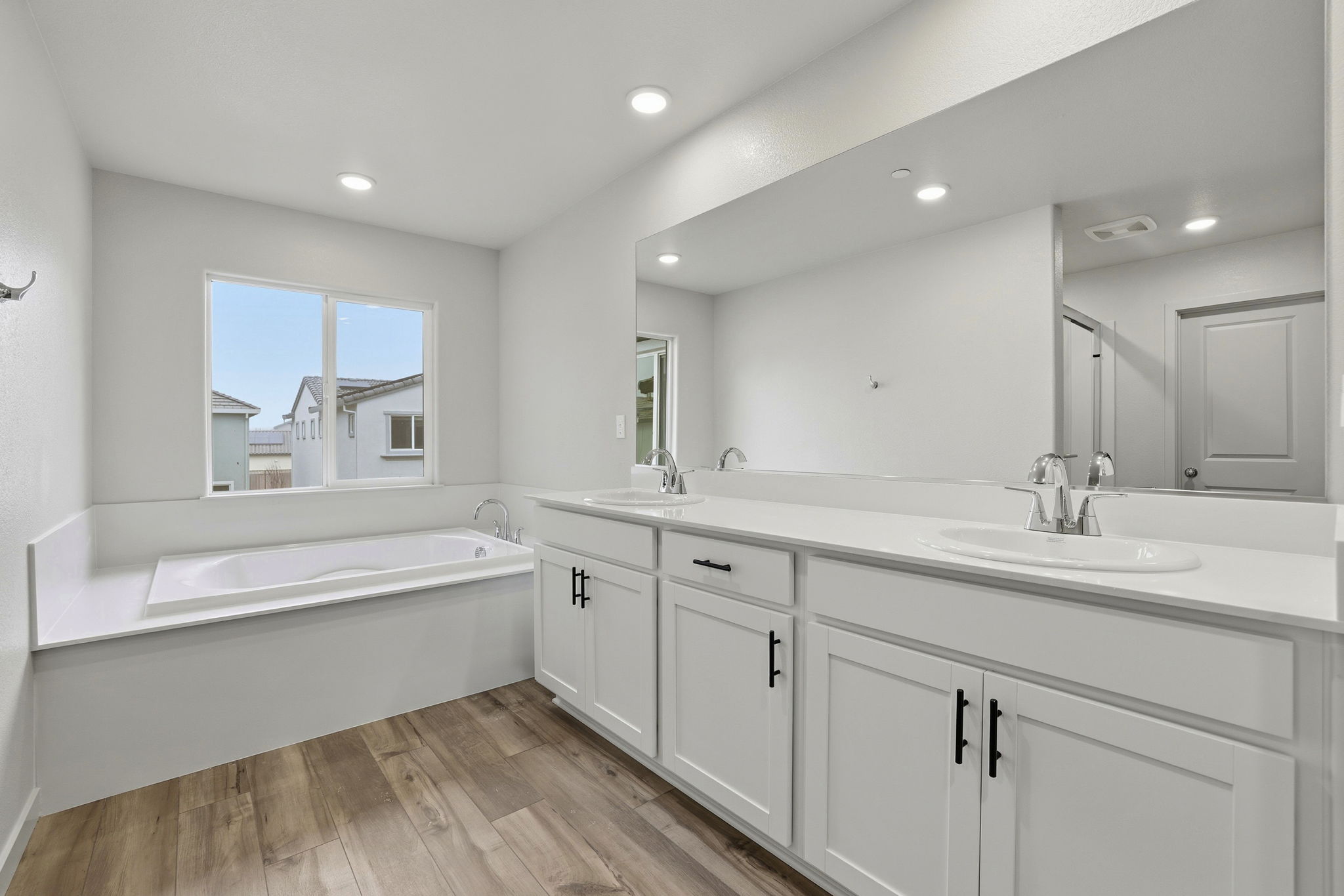 A bathroom with a tub sink and a bathtub.