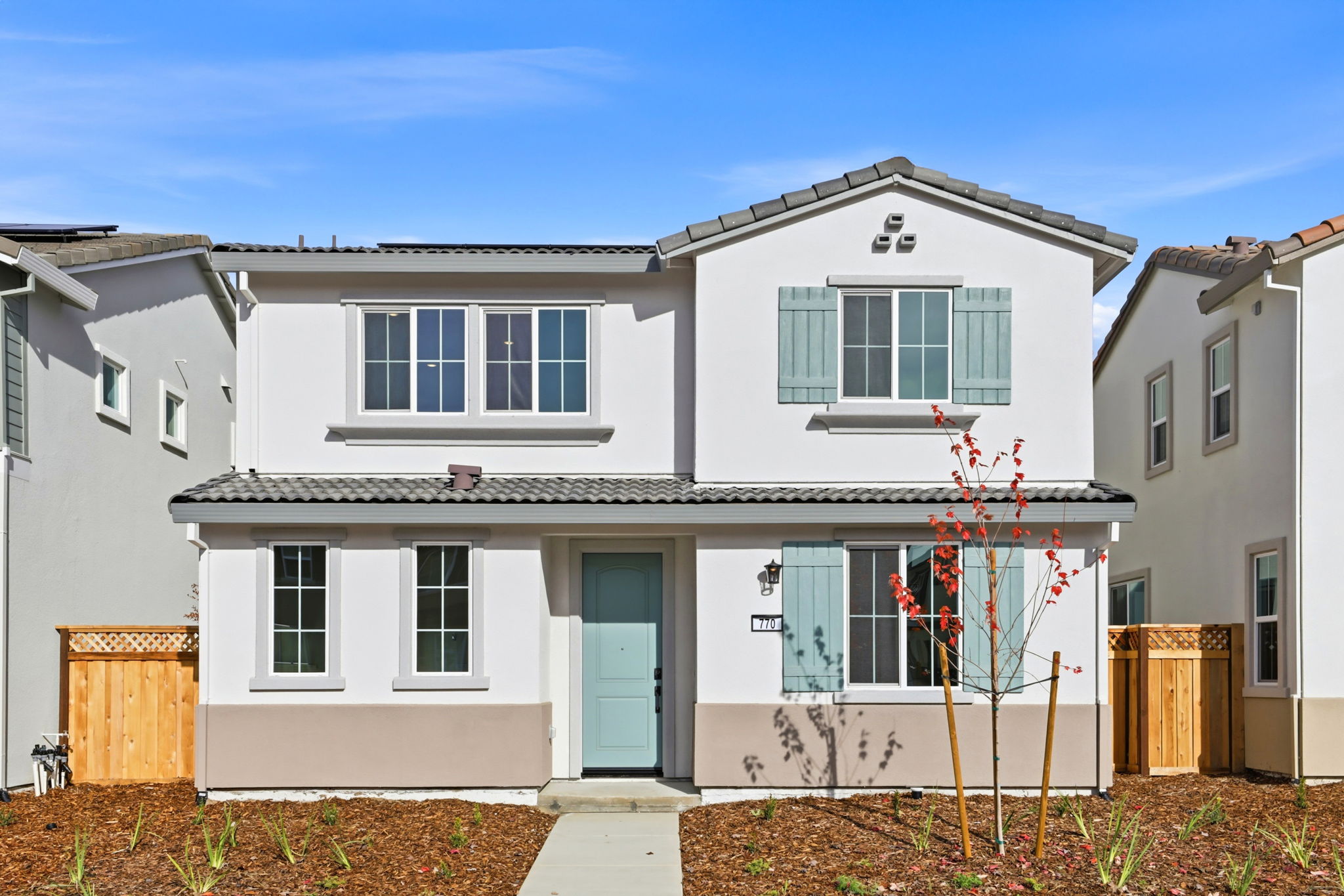 A white house with blue doors.