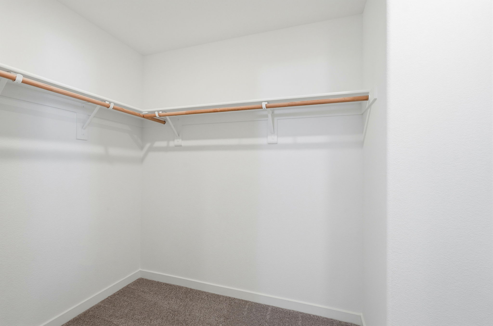 A white wall with a wooden railing.