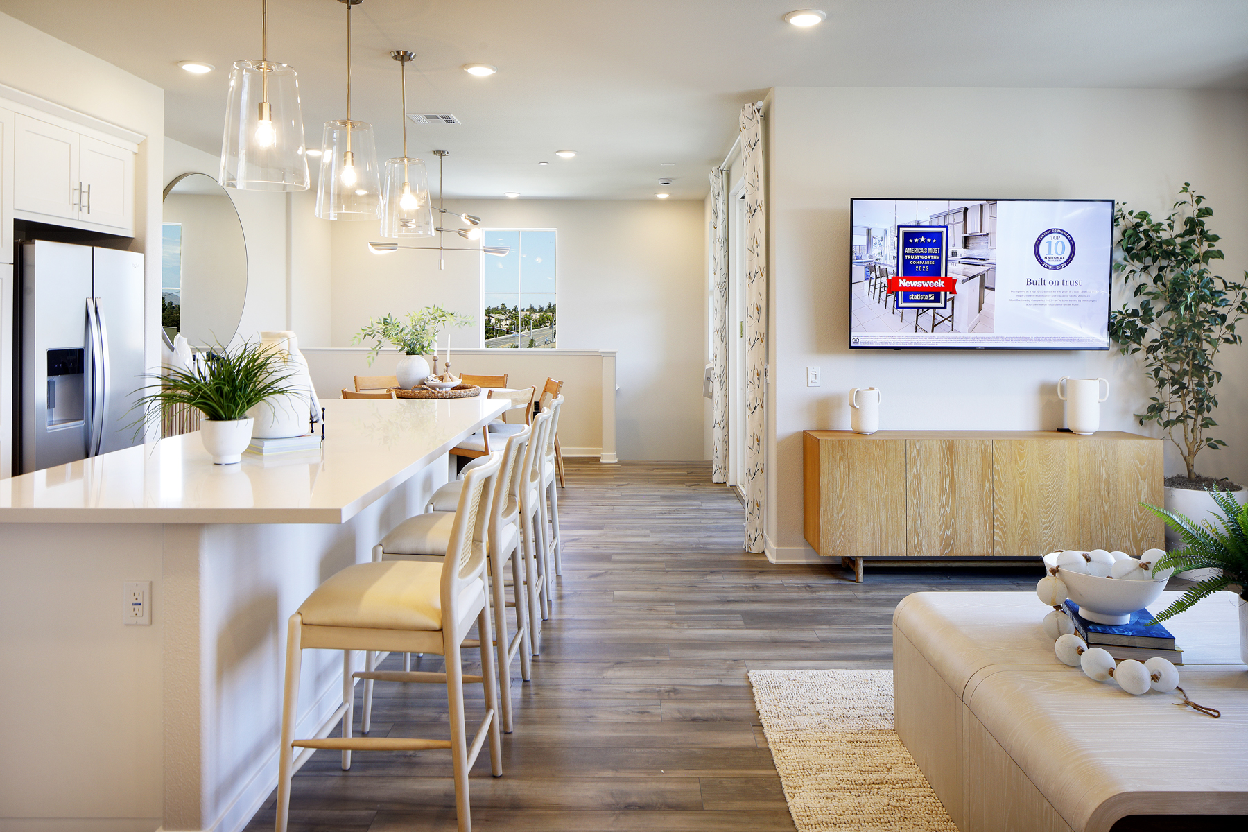 A kitchen with a bar and a tv.