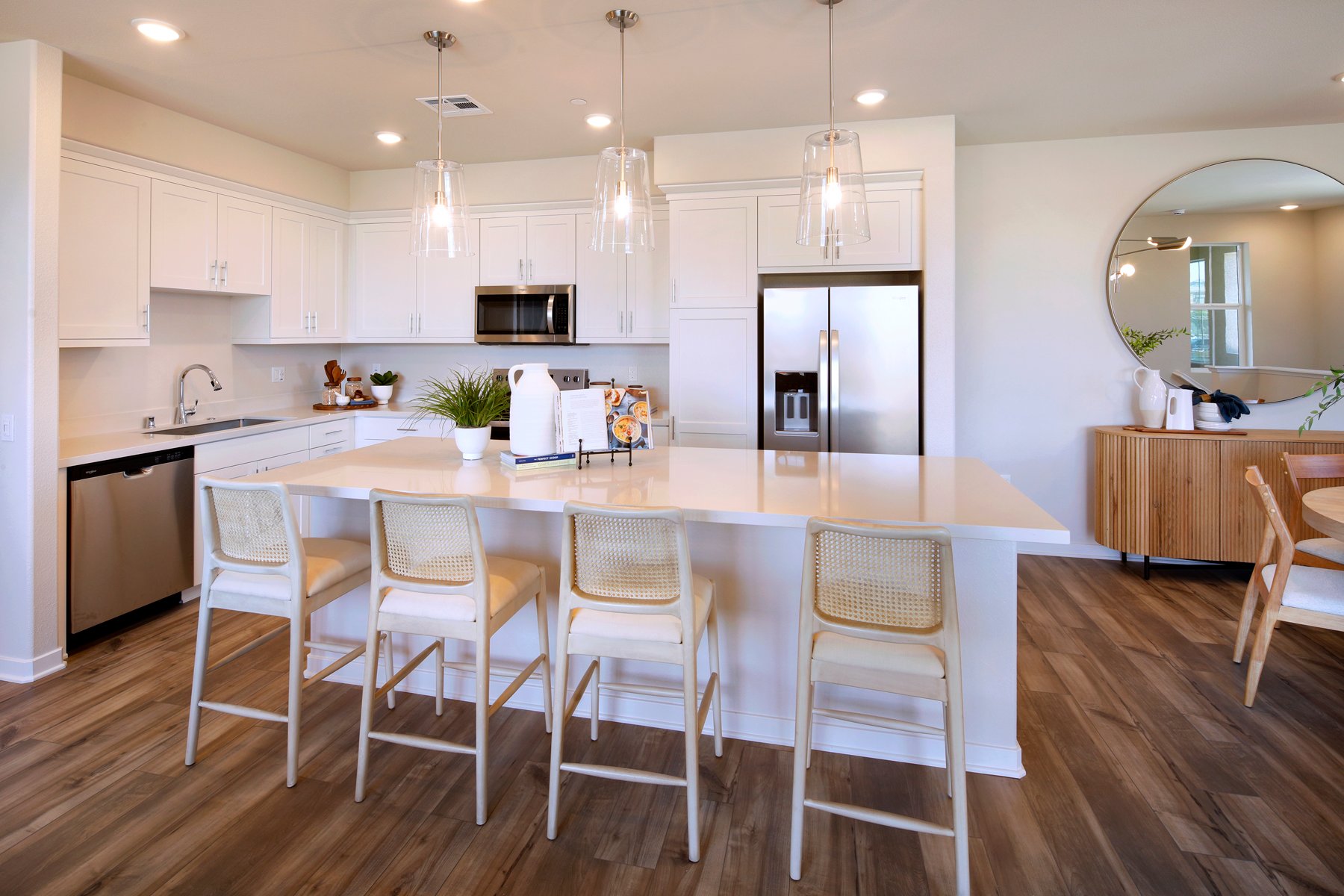 A kitchen with white cabinets.