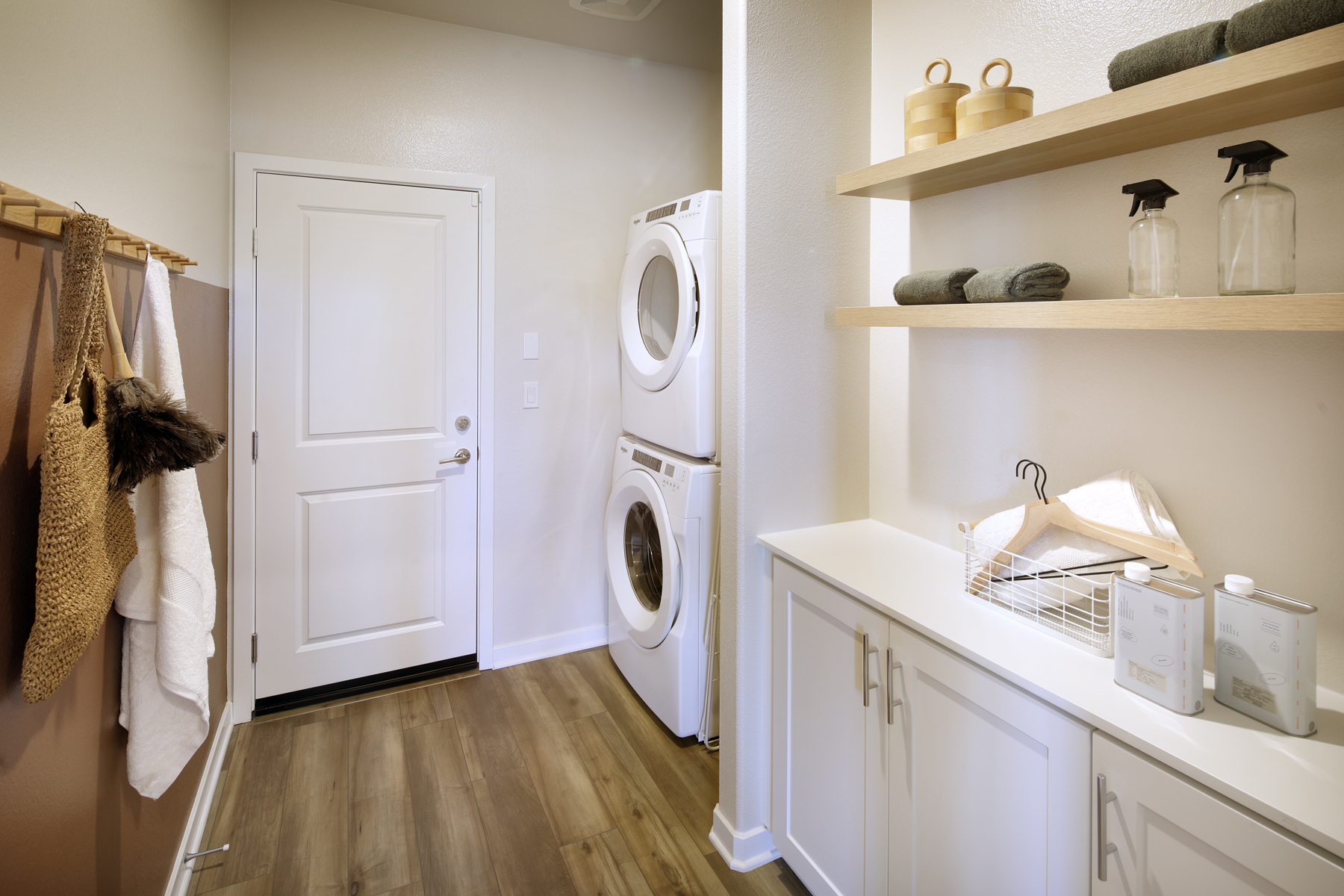 A white kitchen with a washer and dryer.