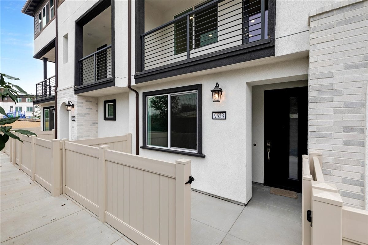 A white building with a white railing.