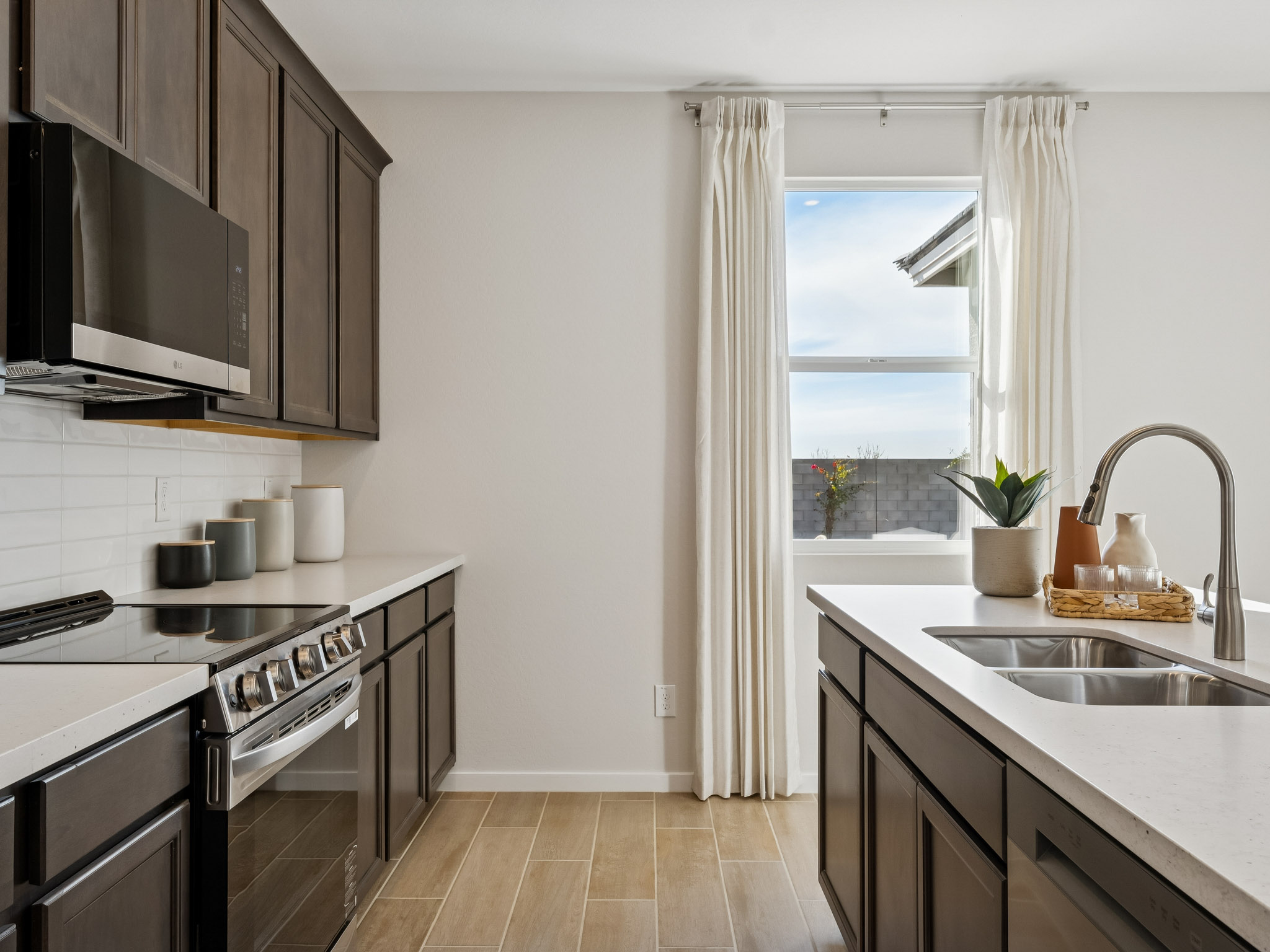 A kitchen with a sink and a window.