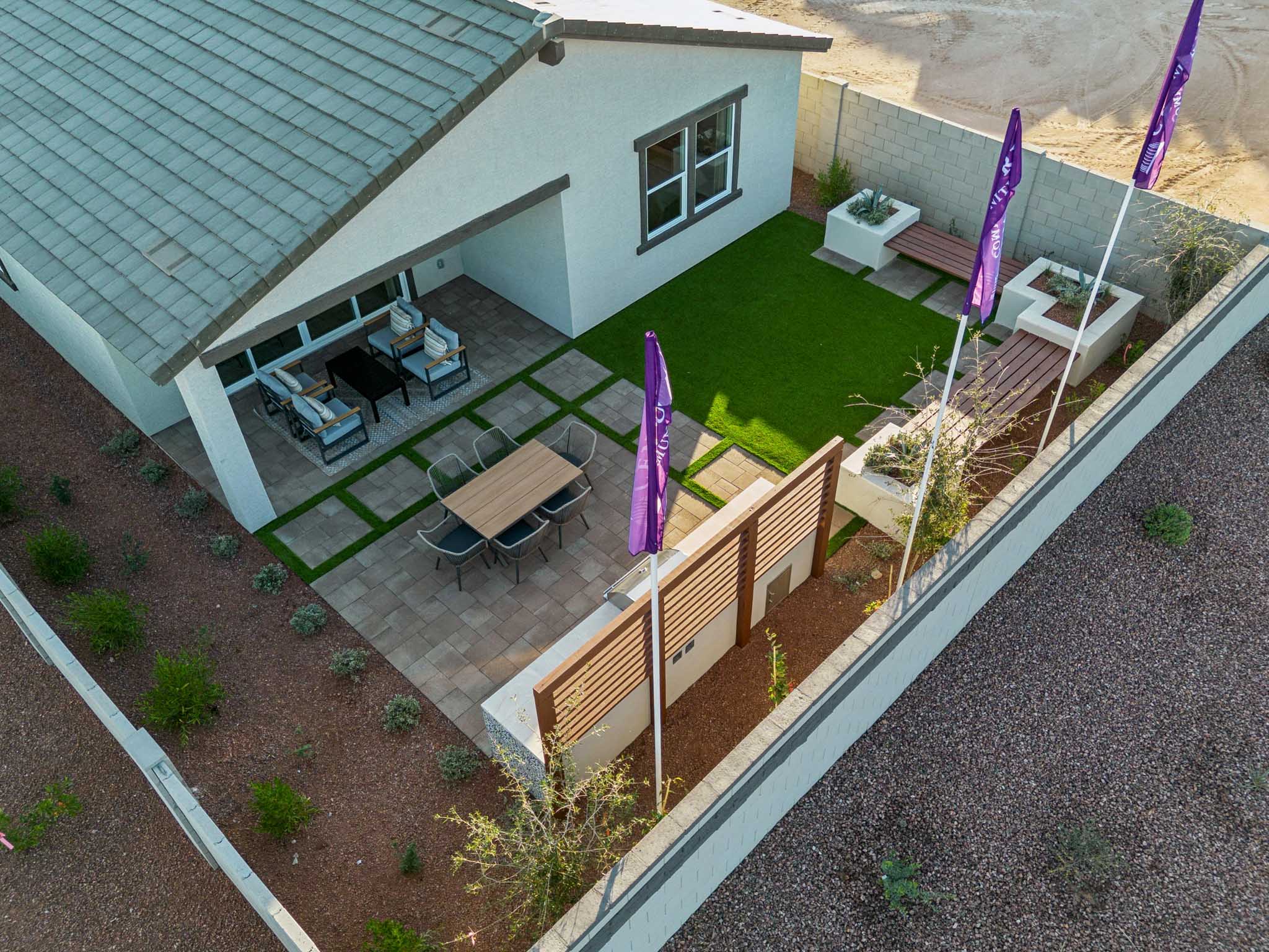 A small backyard with a patio and a swimming pool.