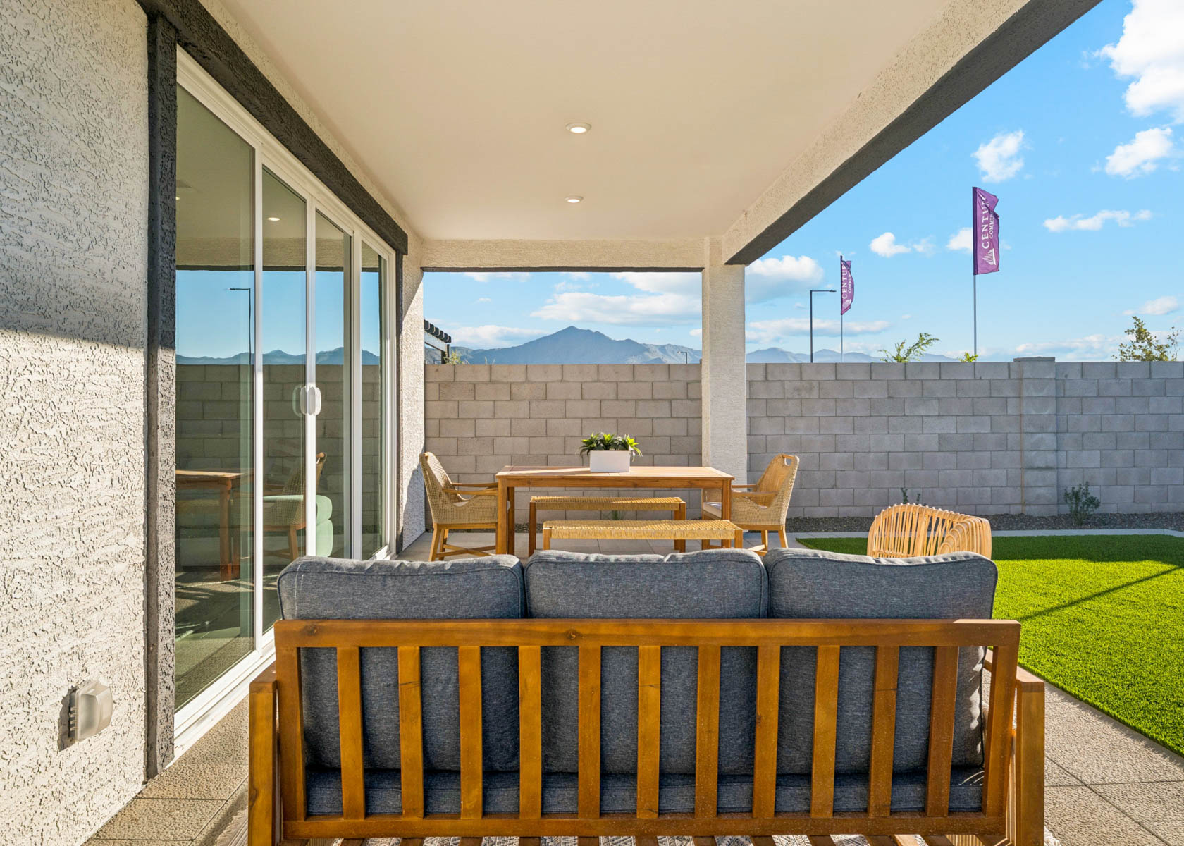 A patio with a table and chairs.
