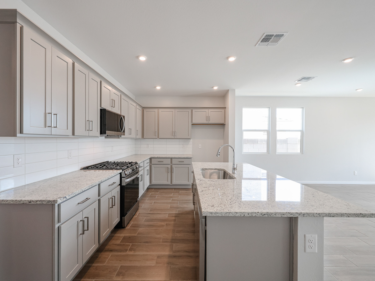 A kitchen with white cabinets.