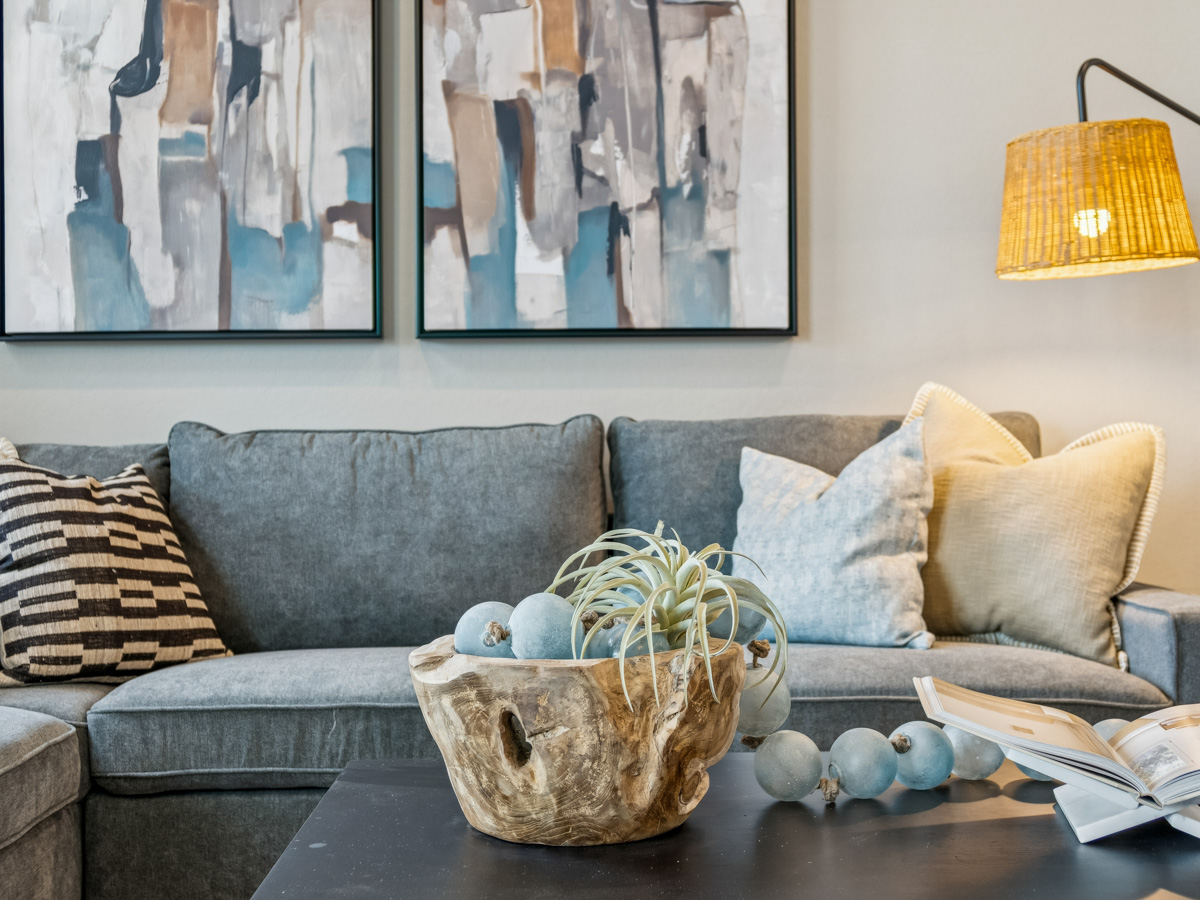 A couch with a basket of eggs.