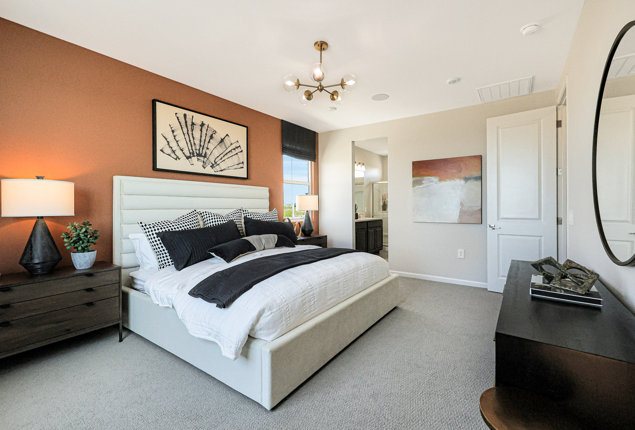 A bedroom with a bed and lamps.