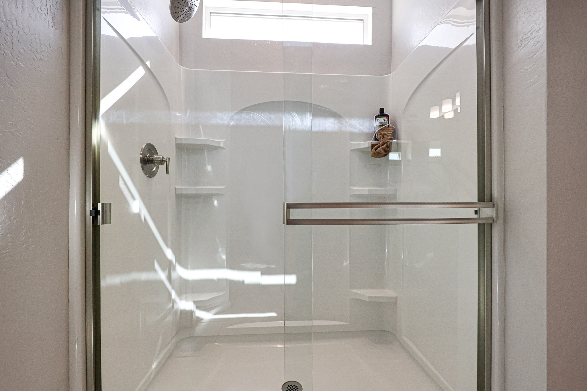 A shower with a glass door.
