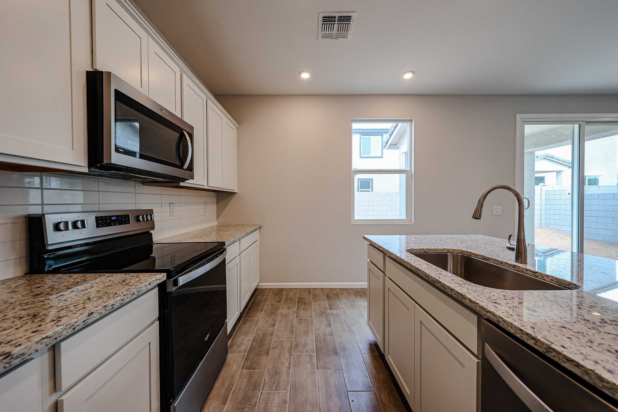 A kitchen with marble counters.