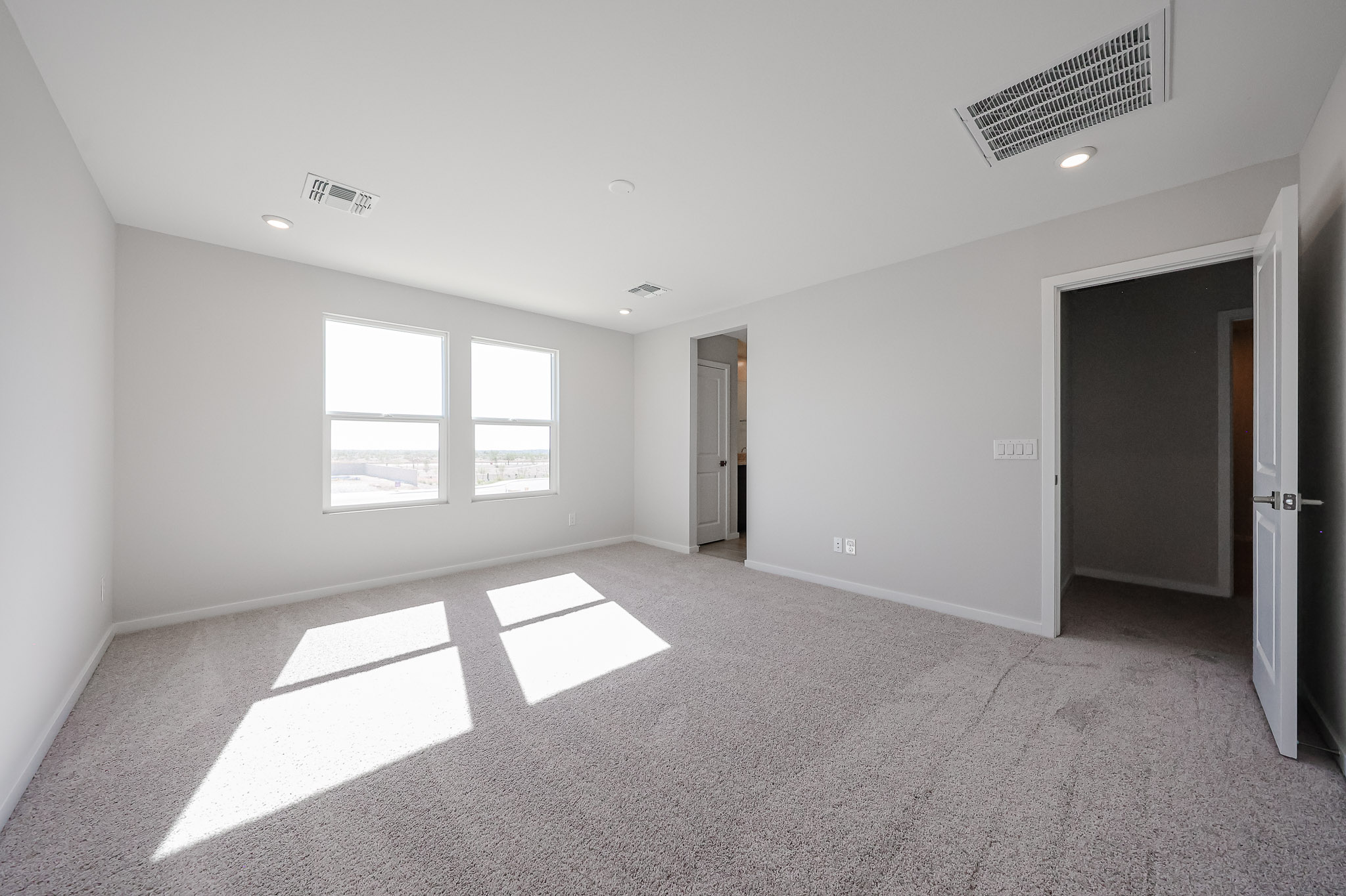 A room with a white floor and a window.
