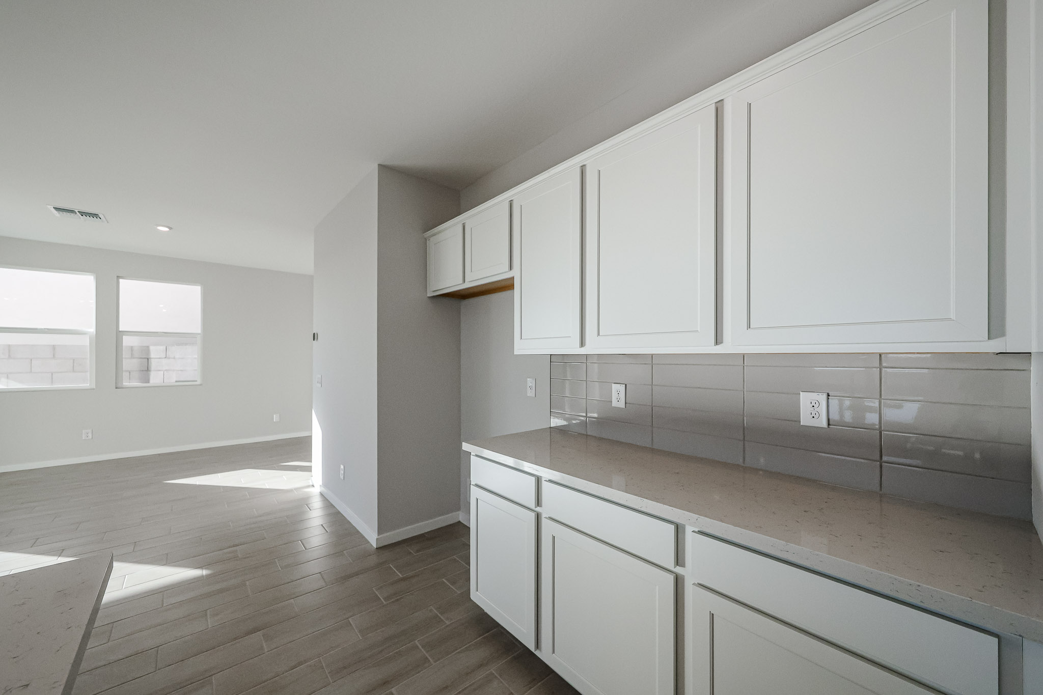 A kitchen with white cabinets.