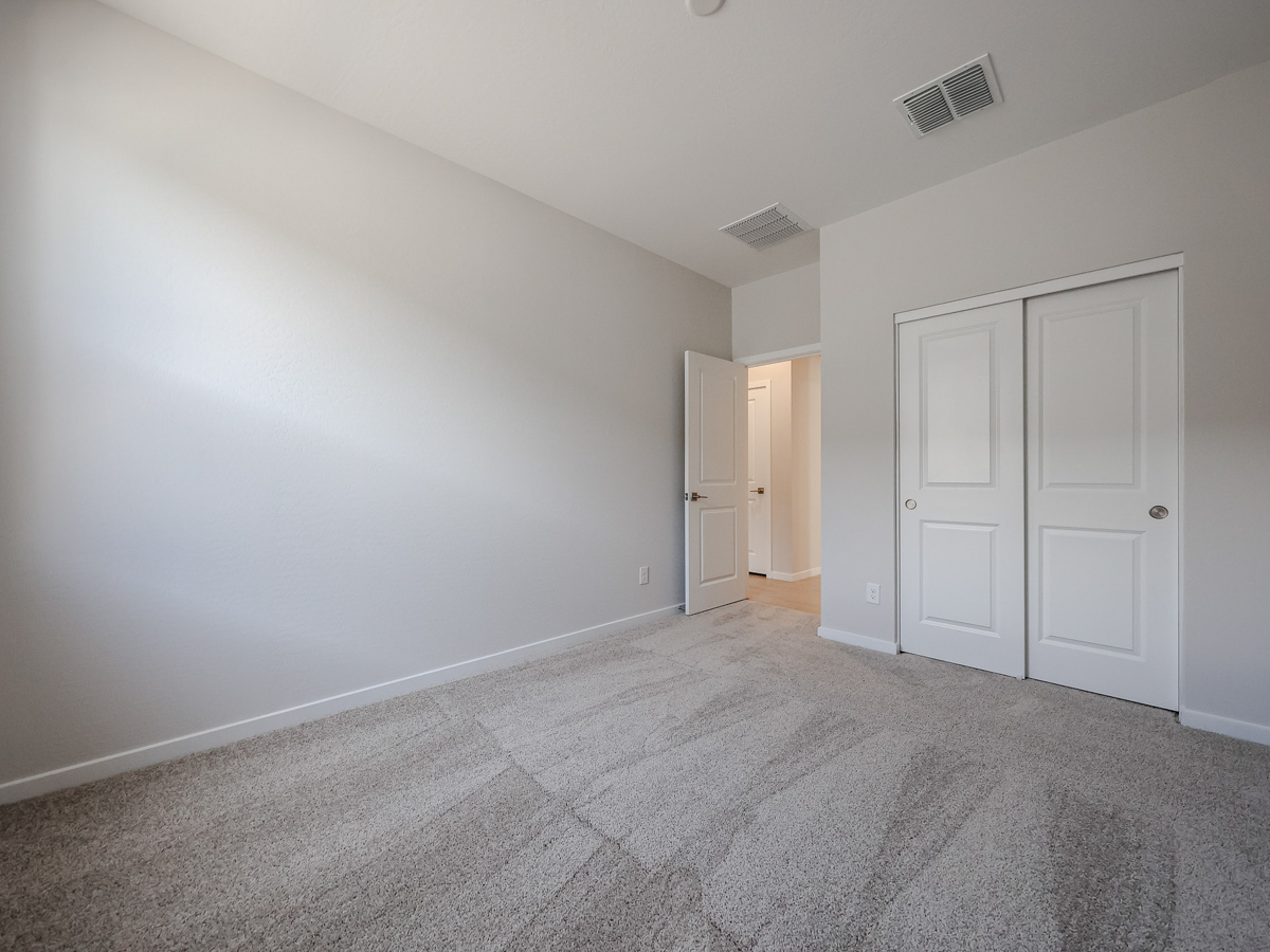 A hallway with white doors.