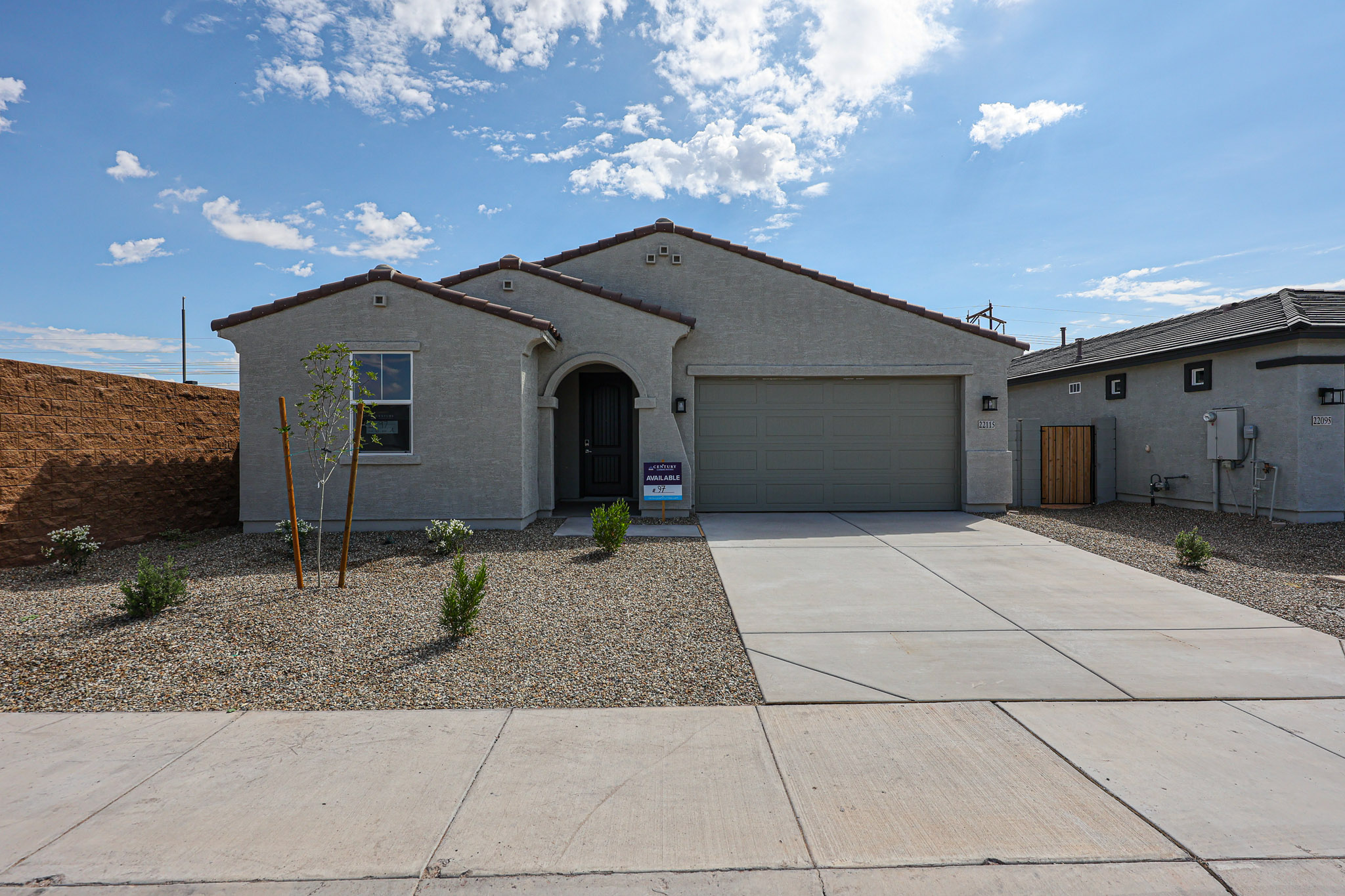 A building with garages and a sidewalk.