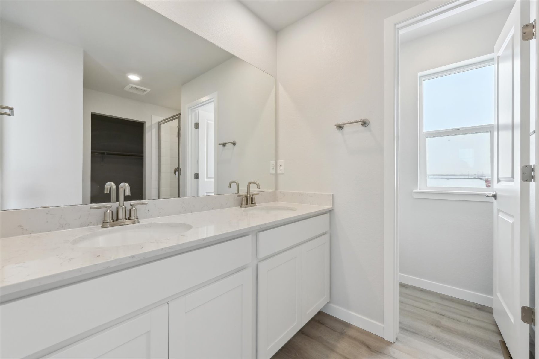 A bathroom with white cabinets.