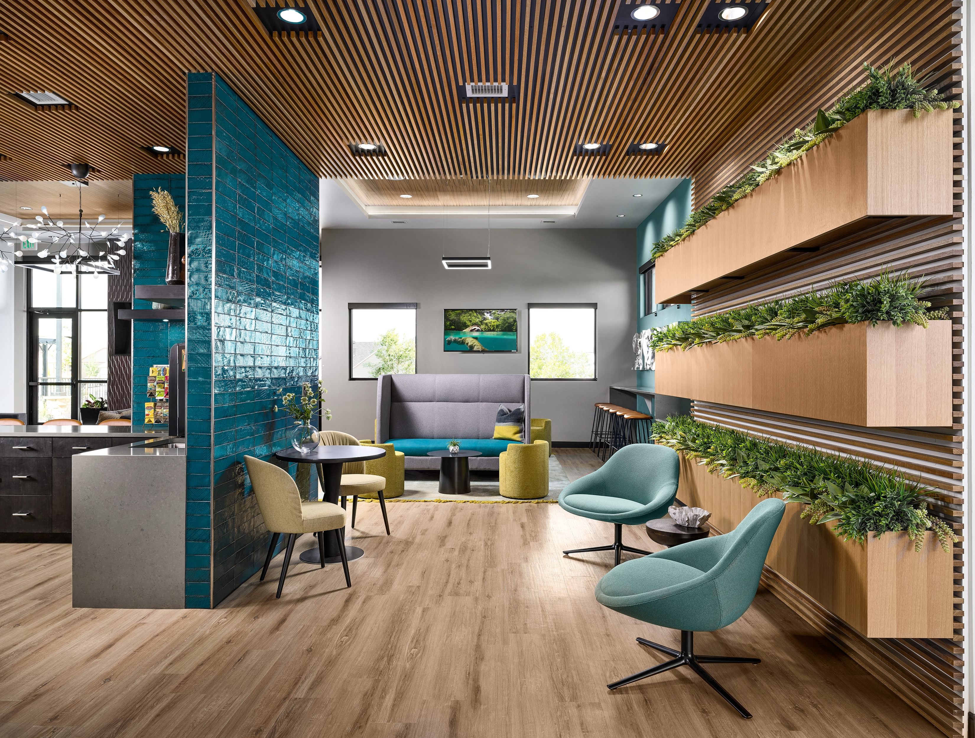 A room with a pool table and chairs.