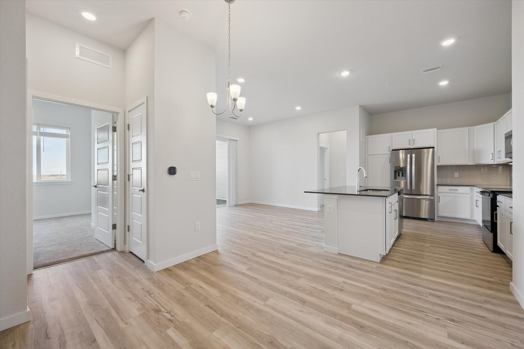 A kitchen with white cabinets.