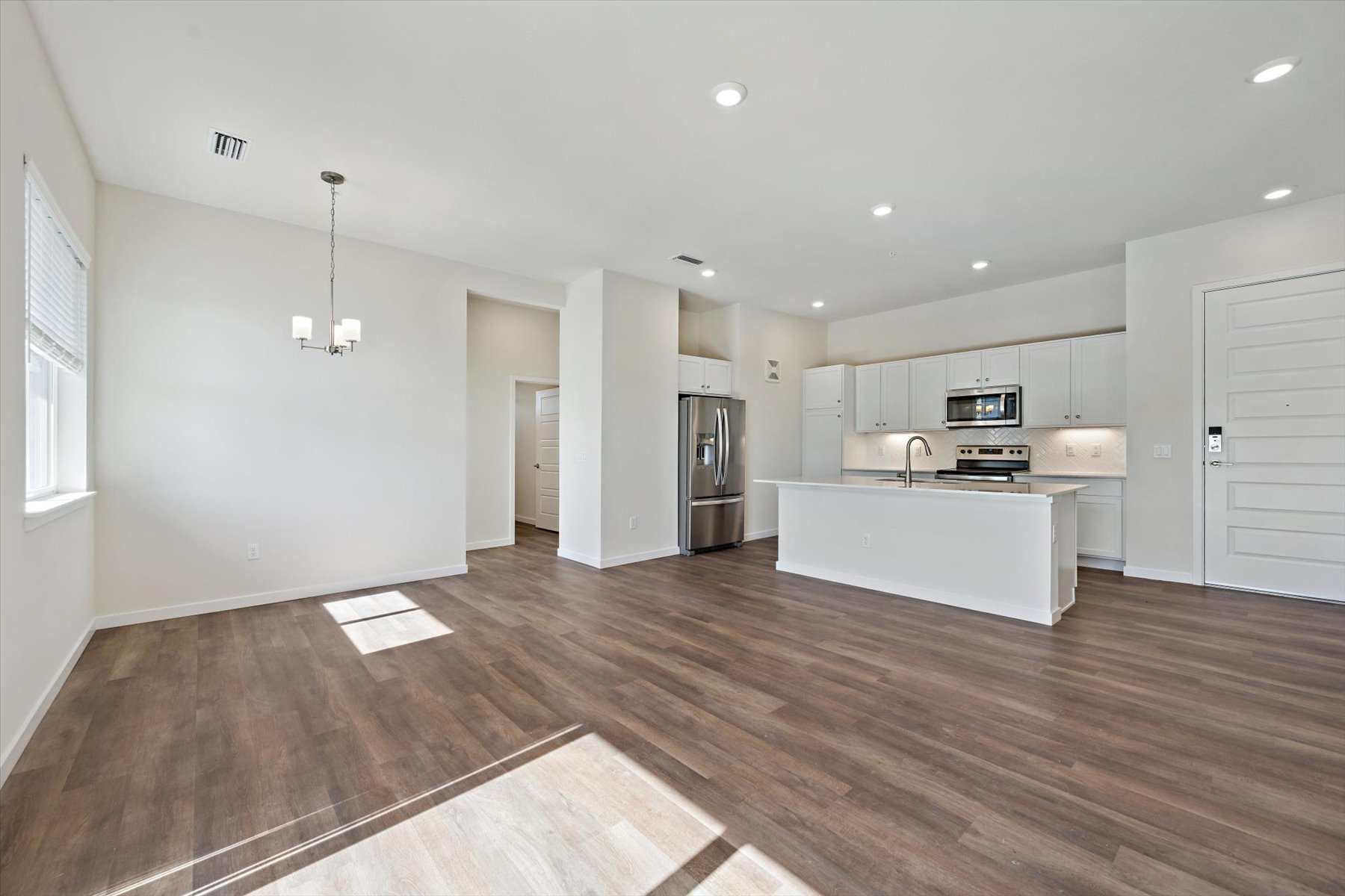 A large kitchen with white cabinets.