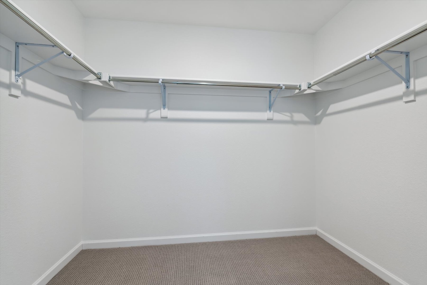 A white staircase with a metal railing.