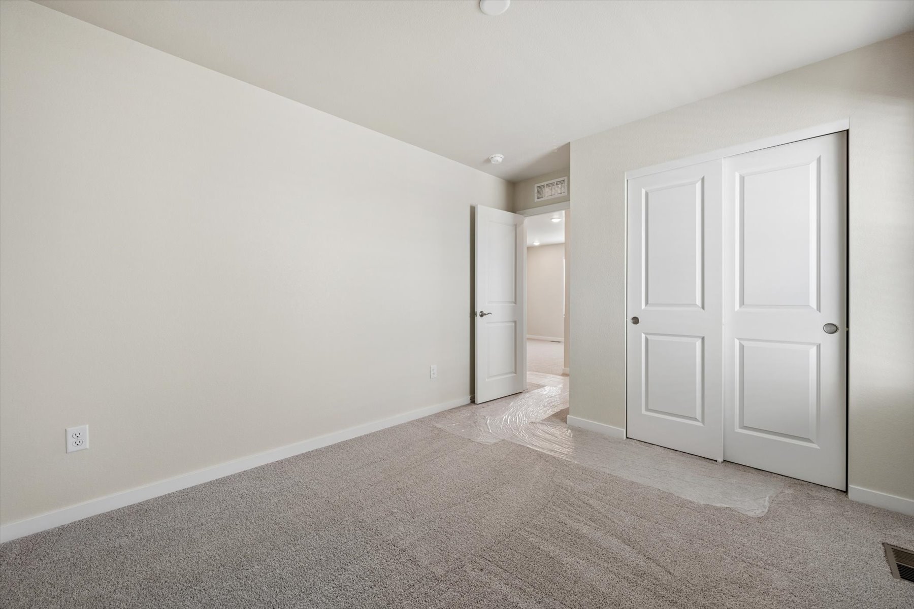 A hallway with white doors.