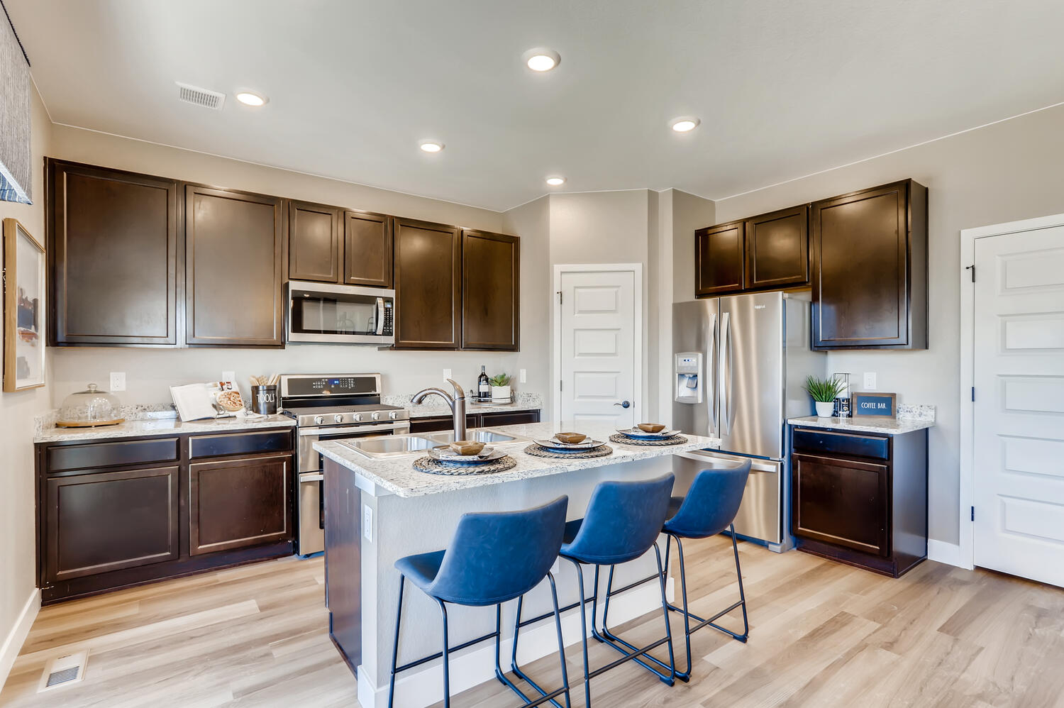 A kitchen with a dining table and chairs.