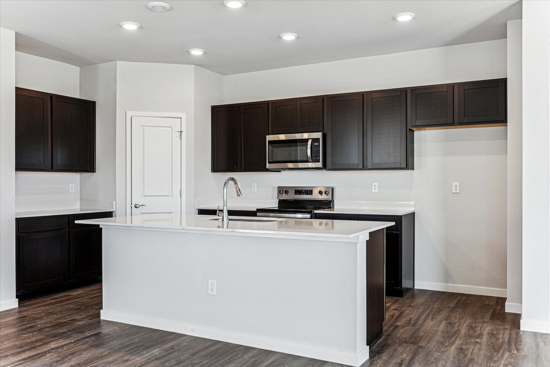 A kitchen with black cabinets.