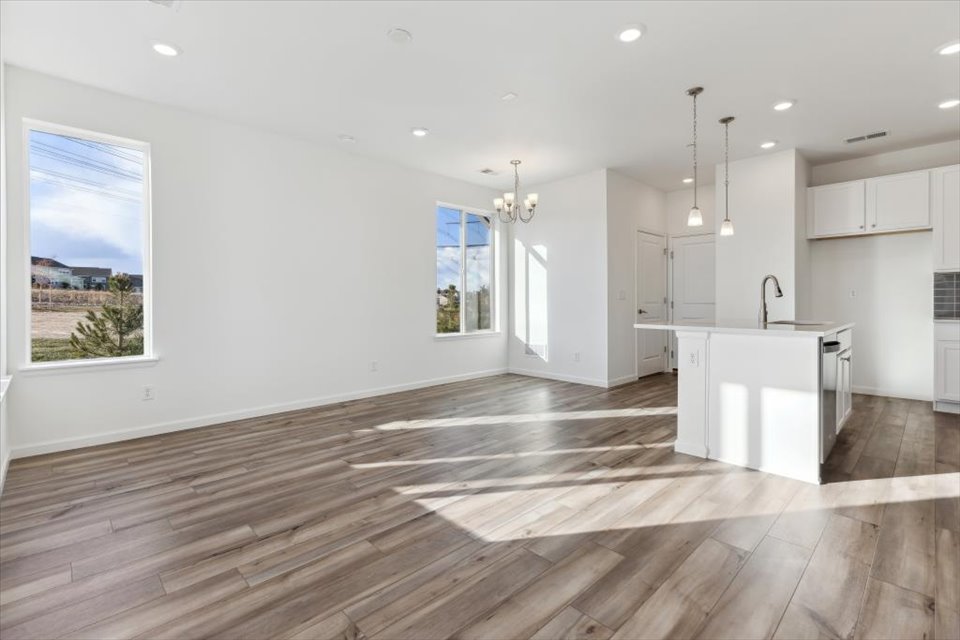 A kitchen with a wood floor.