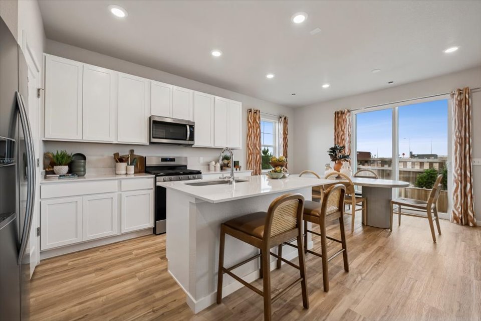 A kitchen with white cabinets.