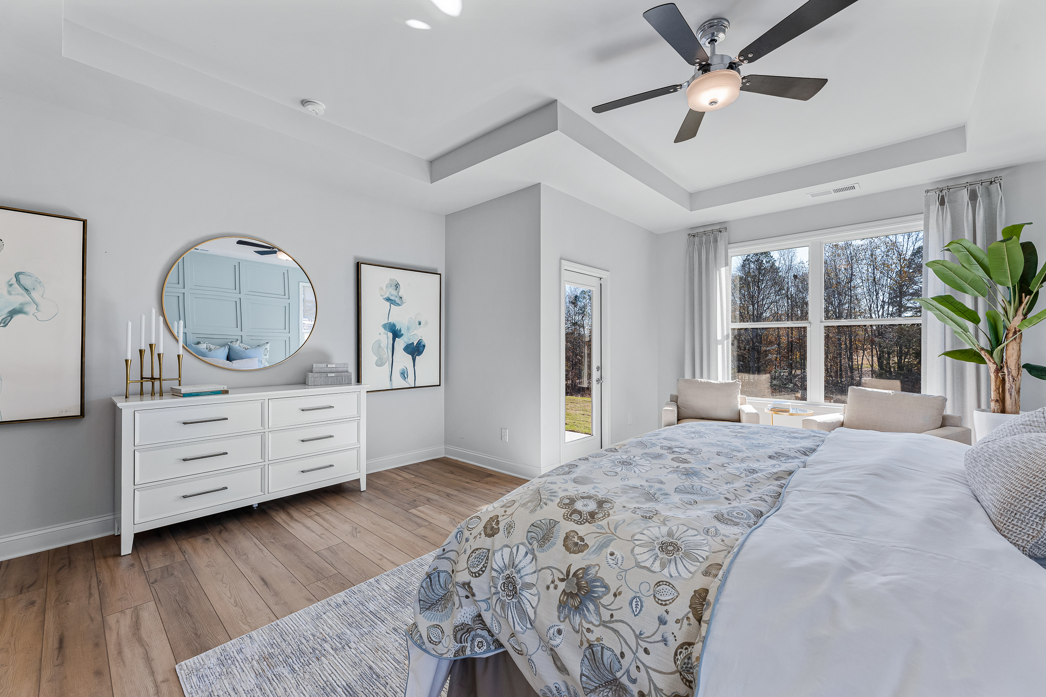 A bedroom with a large bed and a large mirror.