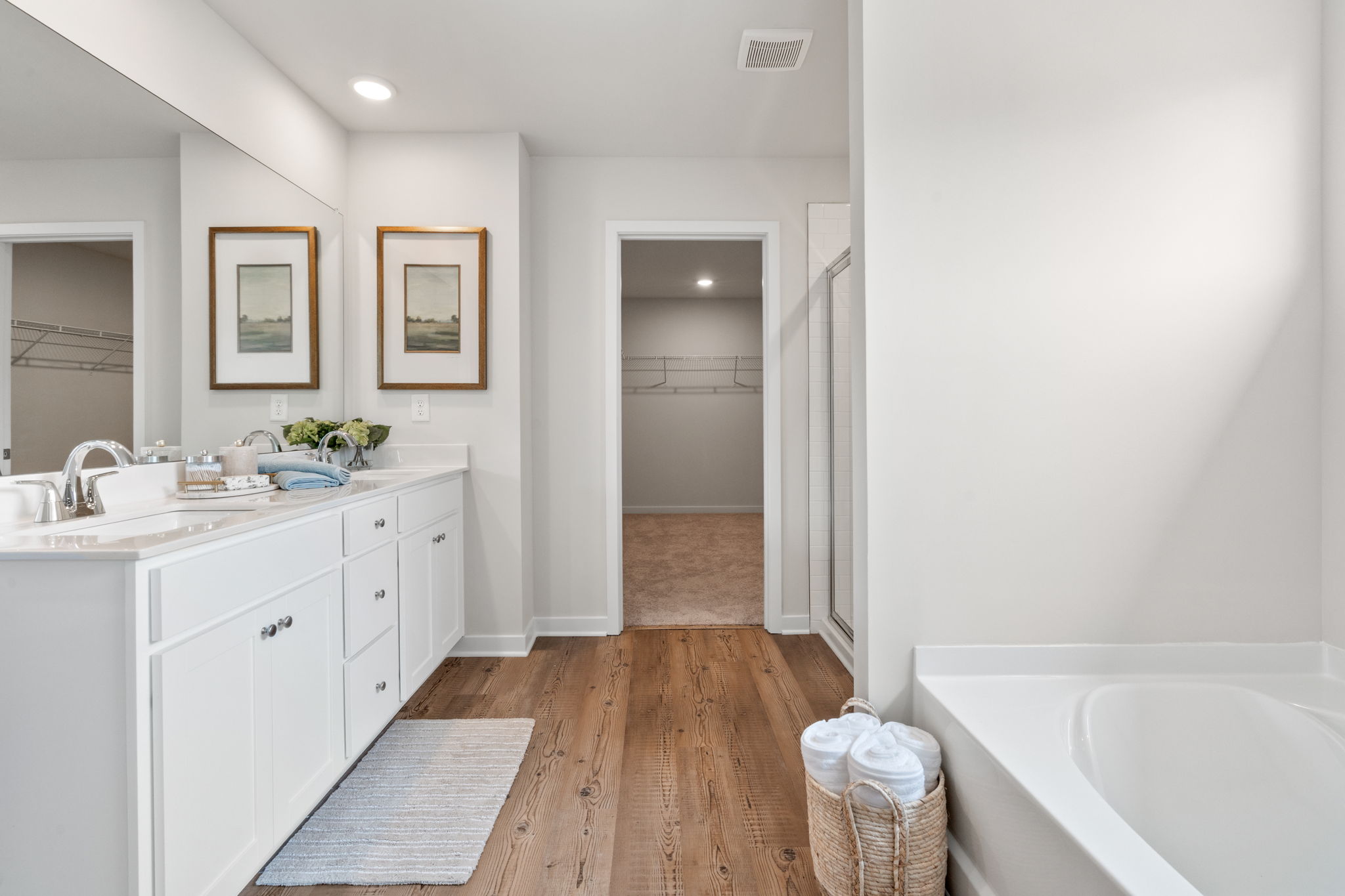 A bathroom with white cabinets.