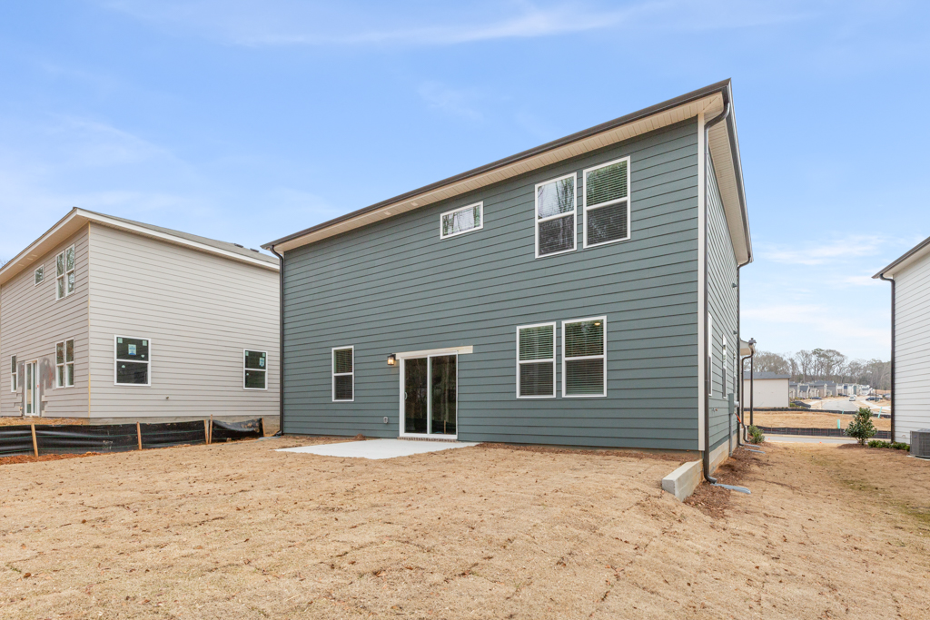 A blue house with a white door with Mark Twain Boyhood Home & Museum in the background.
