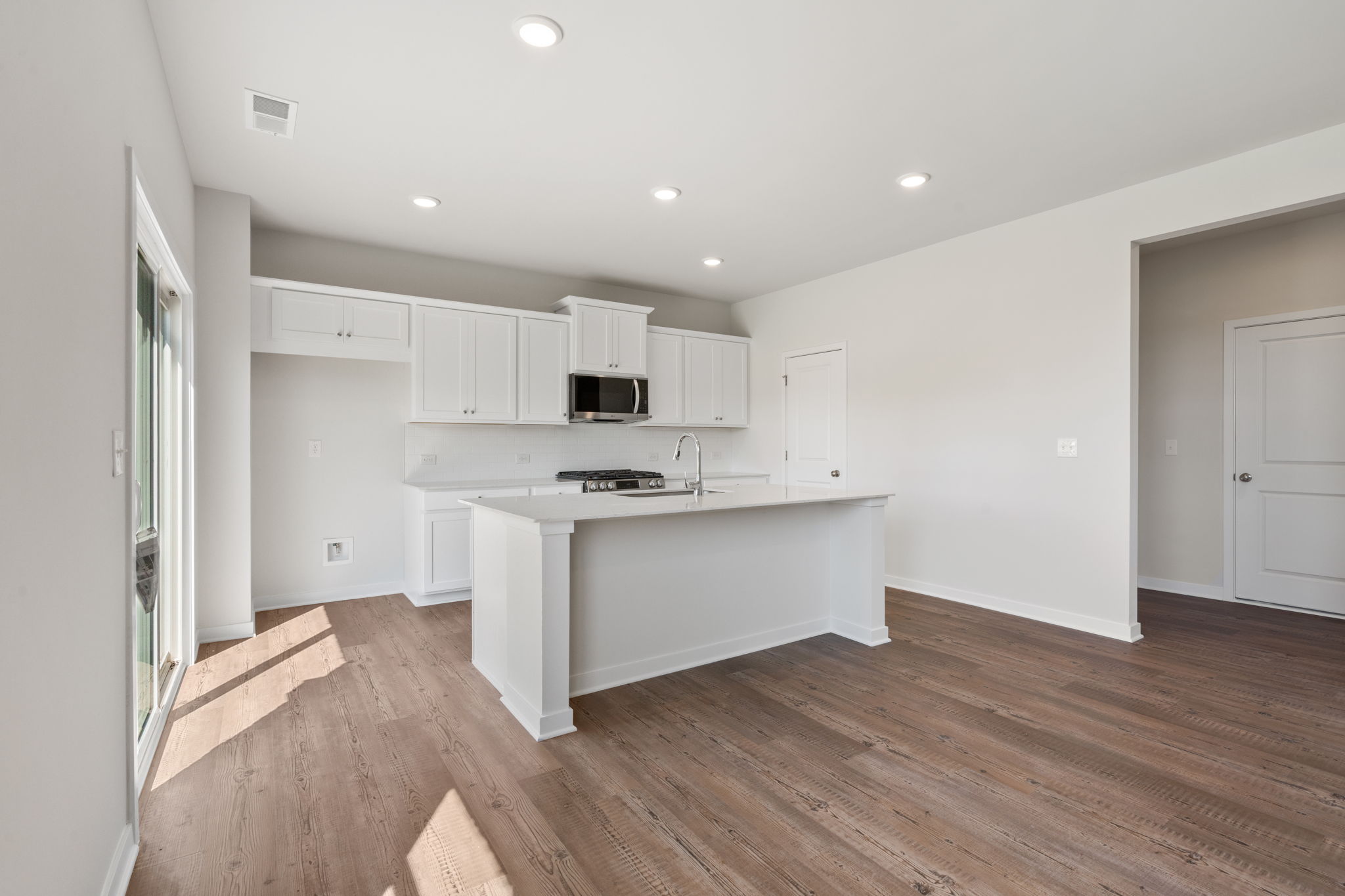 A kitchen with white cabinets.