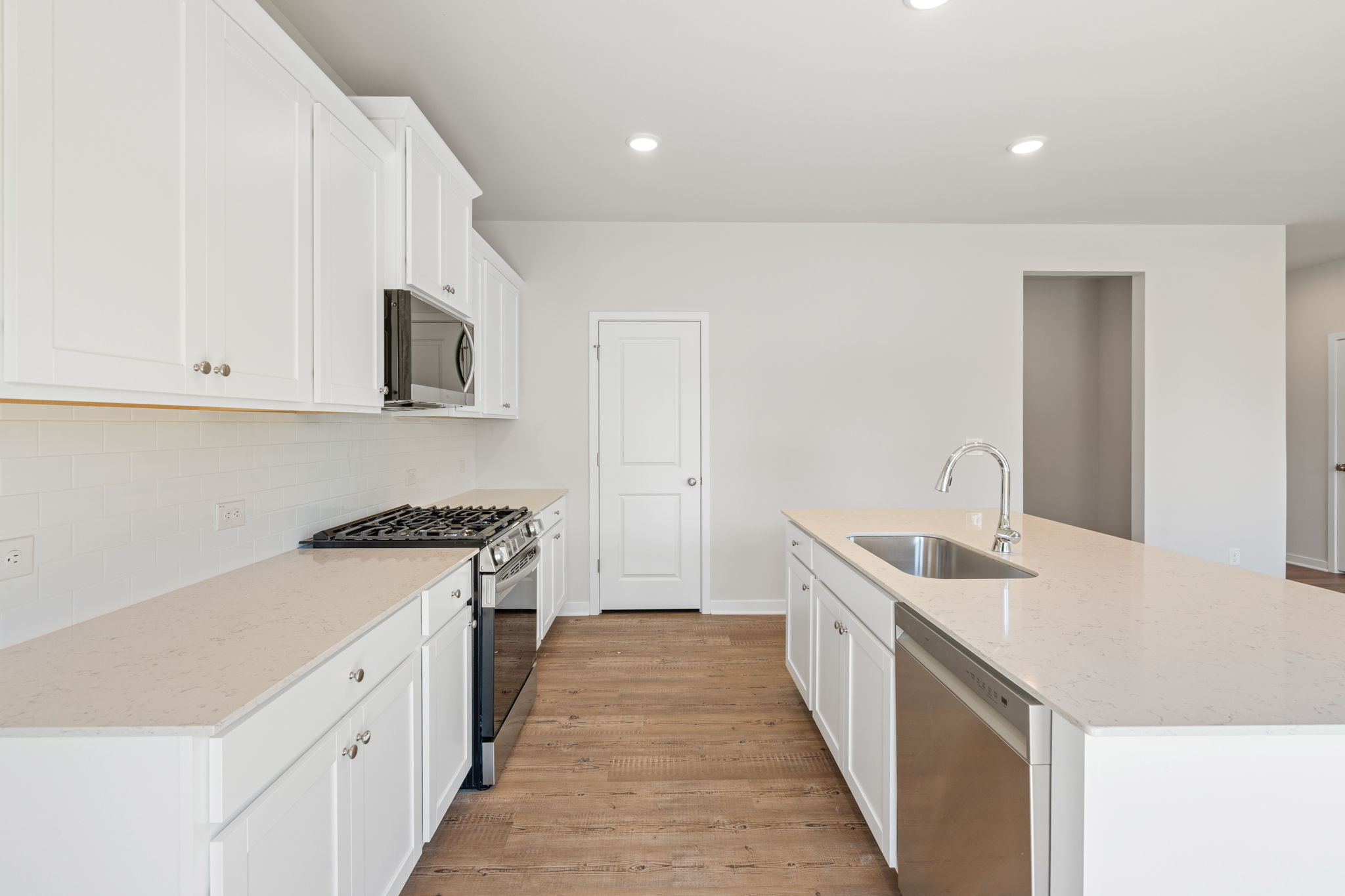 A kitchen with white cabinets.