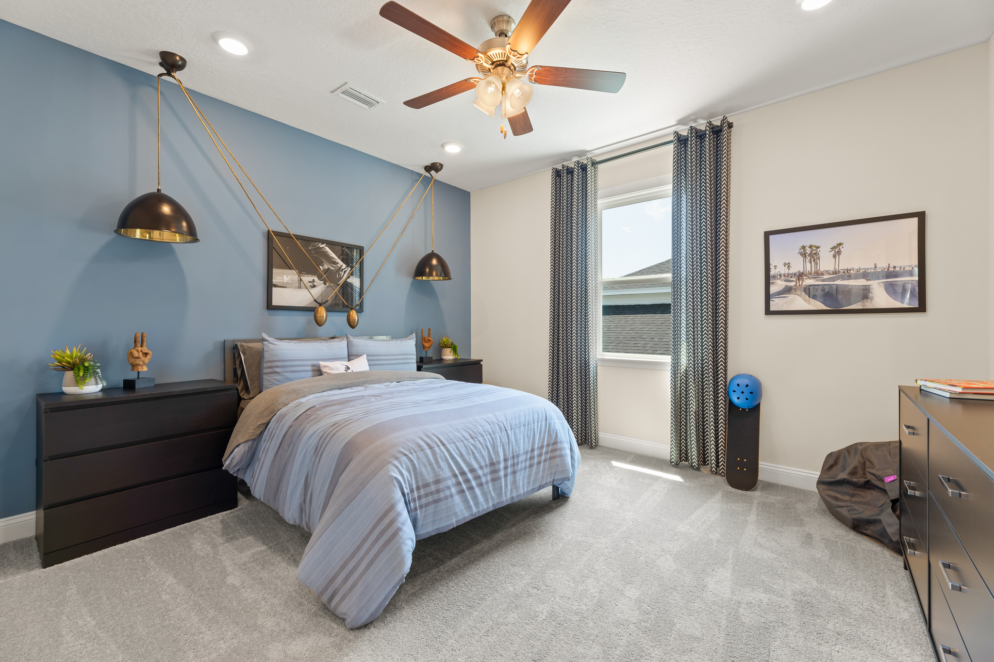 A bedroom with a bed and a fan.