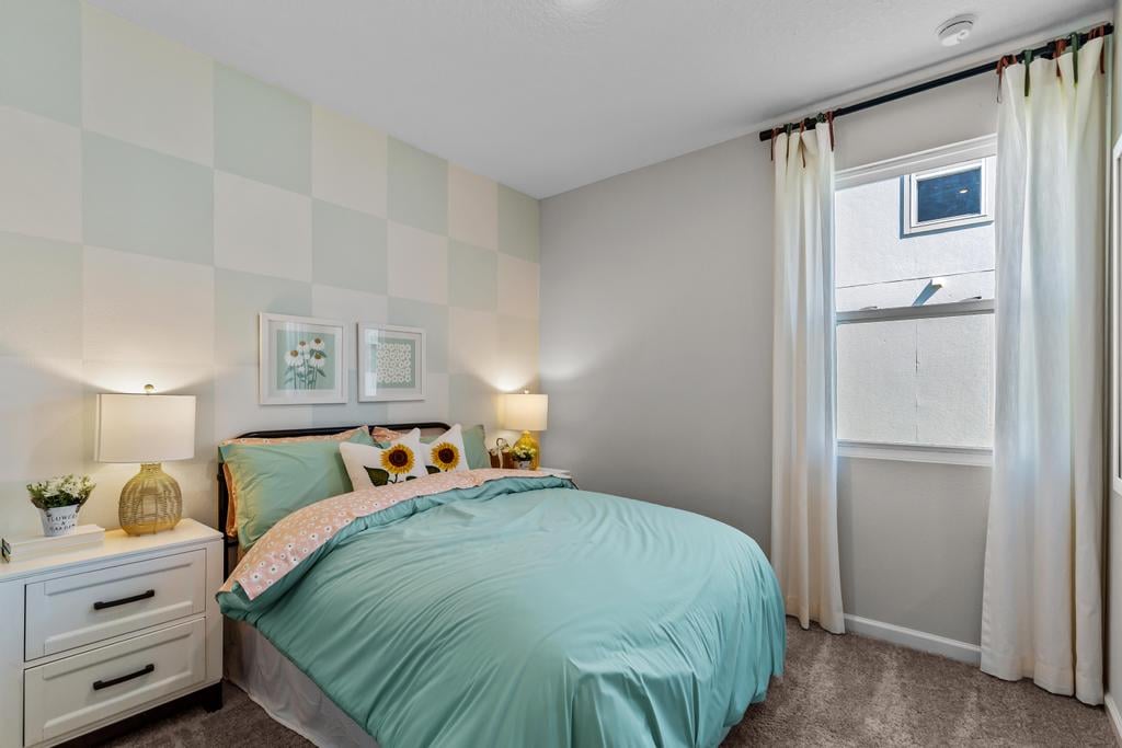 A bedroom with a bed and a window.