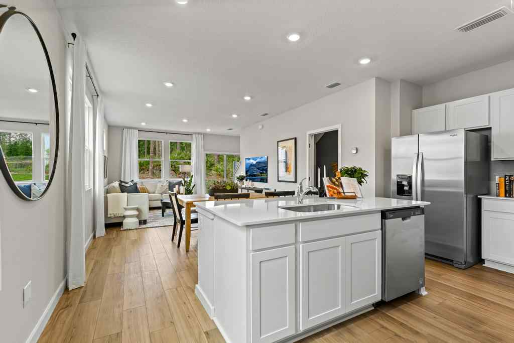A kitchen with white cabinets.