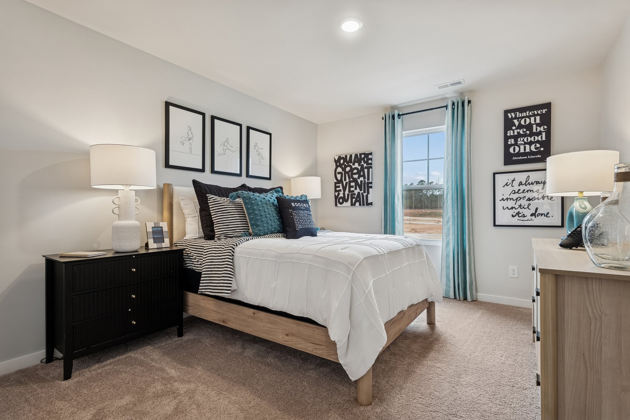A bedroom with a bed and lamps.