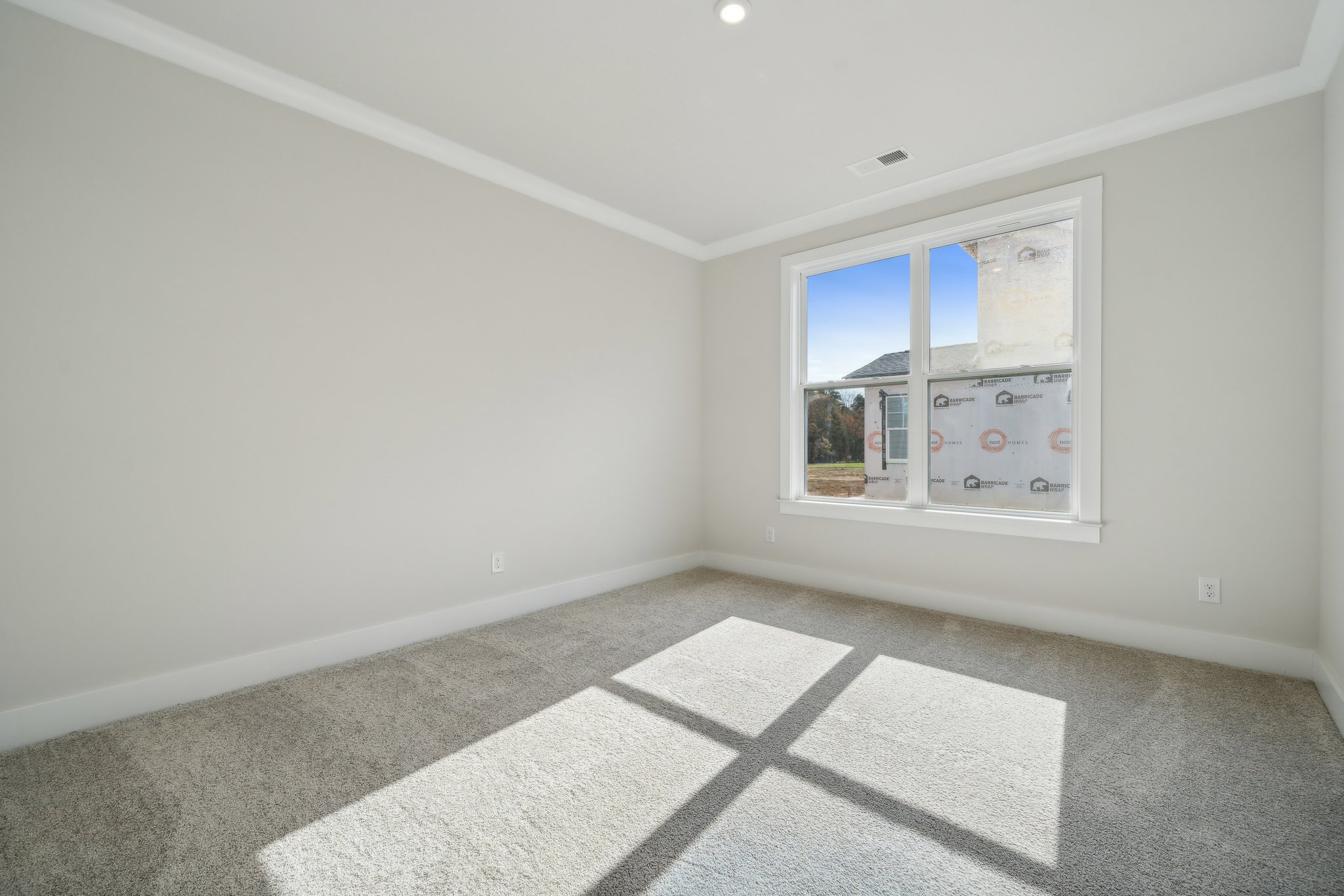 A room with a window and a tile floor.