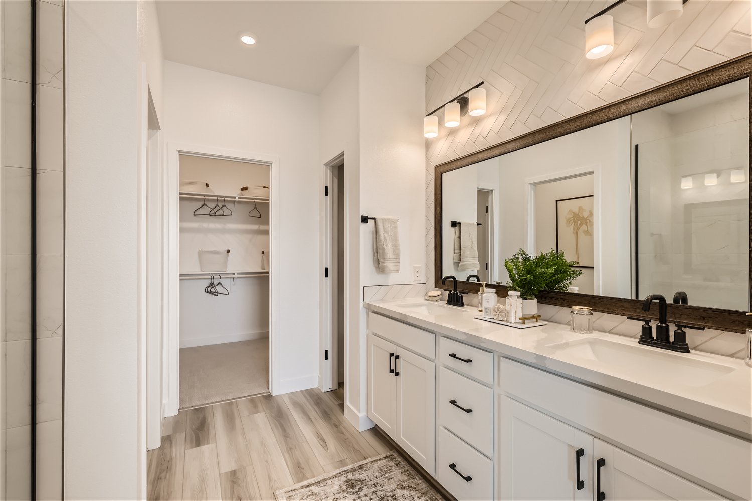 A bathroom with a large mirror.
