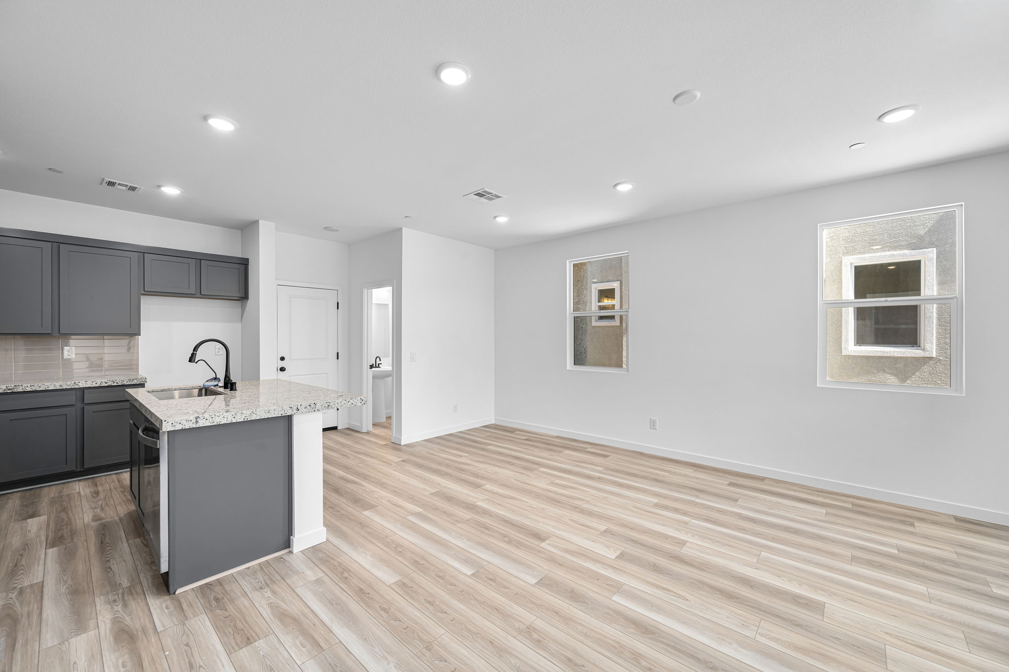 A kitchen with a wood floor.