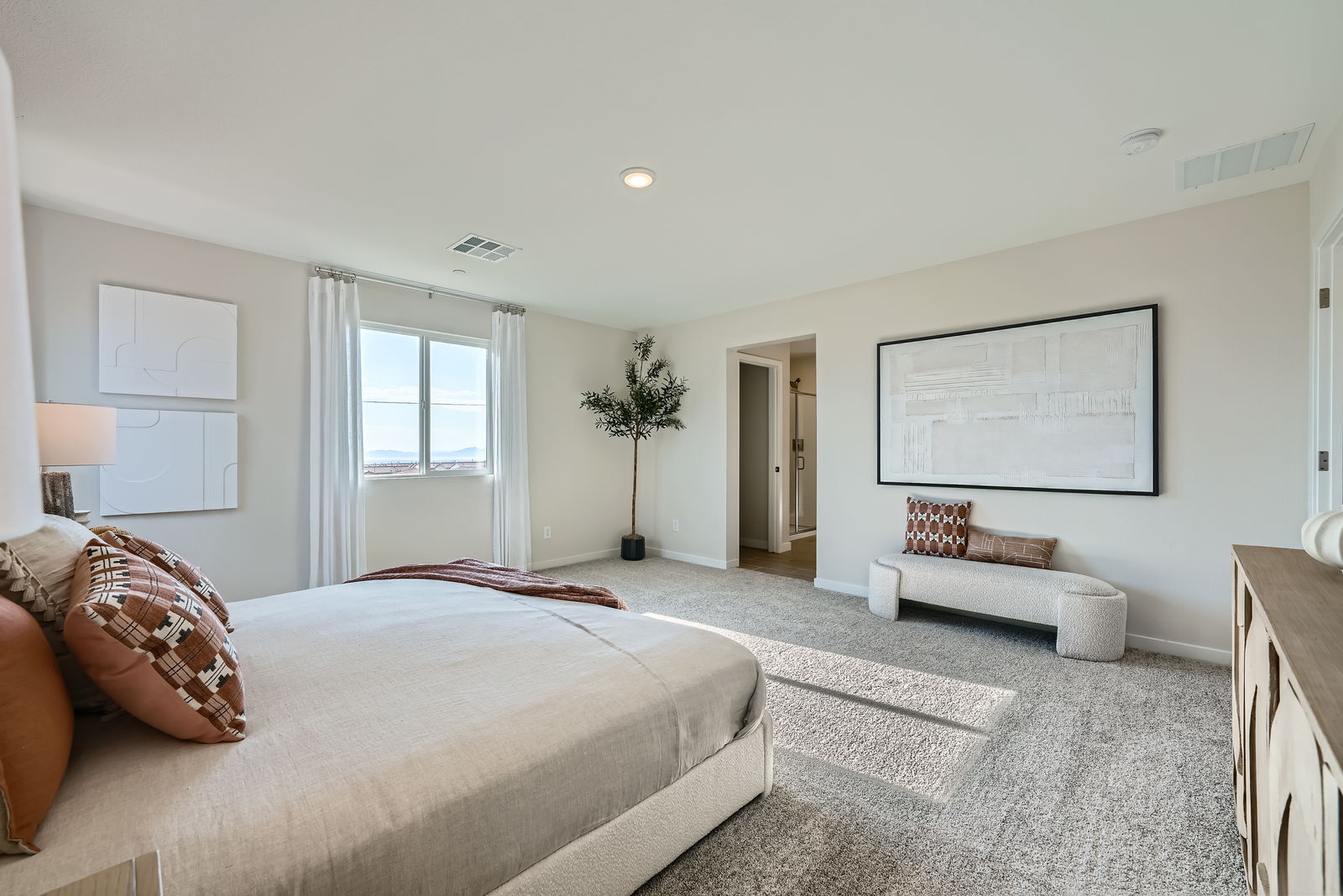 A bedroom with a large bed and a couch.