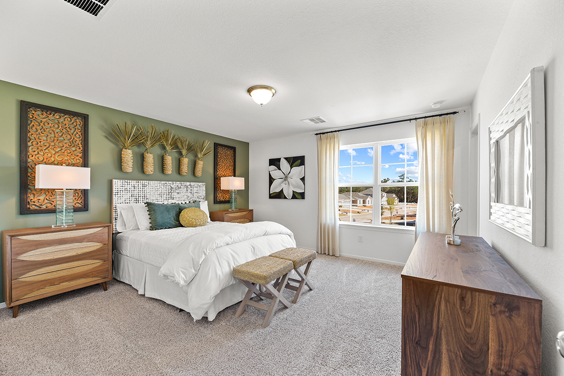 A bedroom with a bed and a desk.