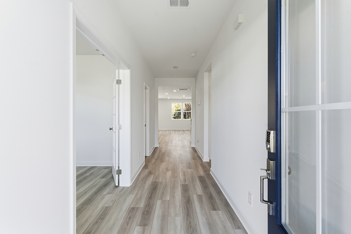 A hallway with white doors.